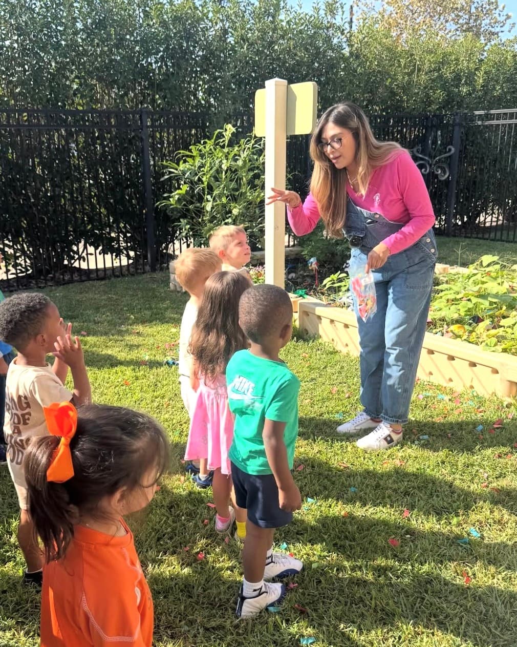 teacher in the Primrose patch teaching children about planting seed