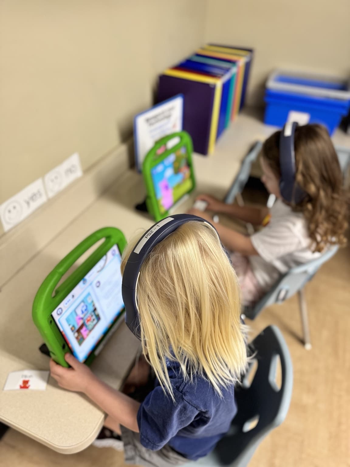 Preschool students using tablets and headphones to engage with the Primrose Balanced Learning app at Primrose School of Braselton.