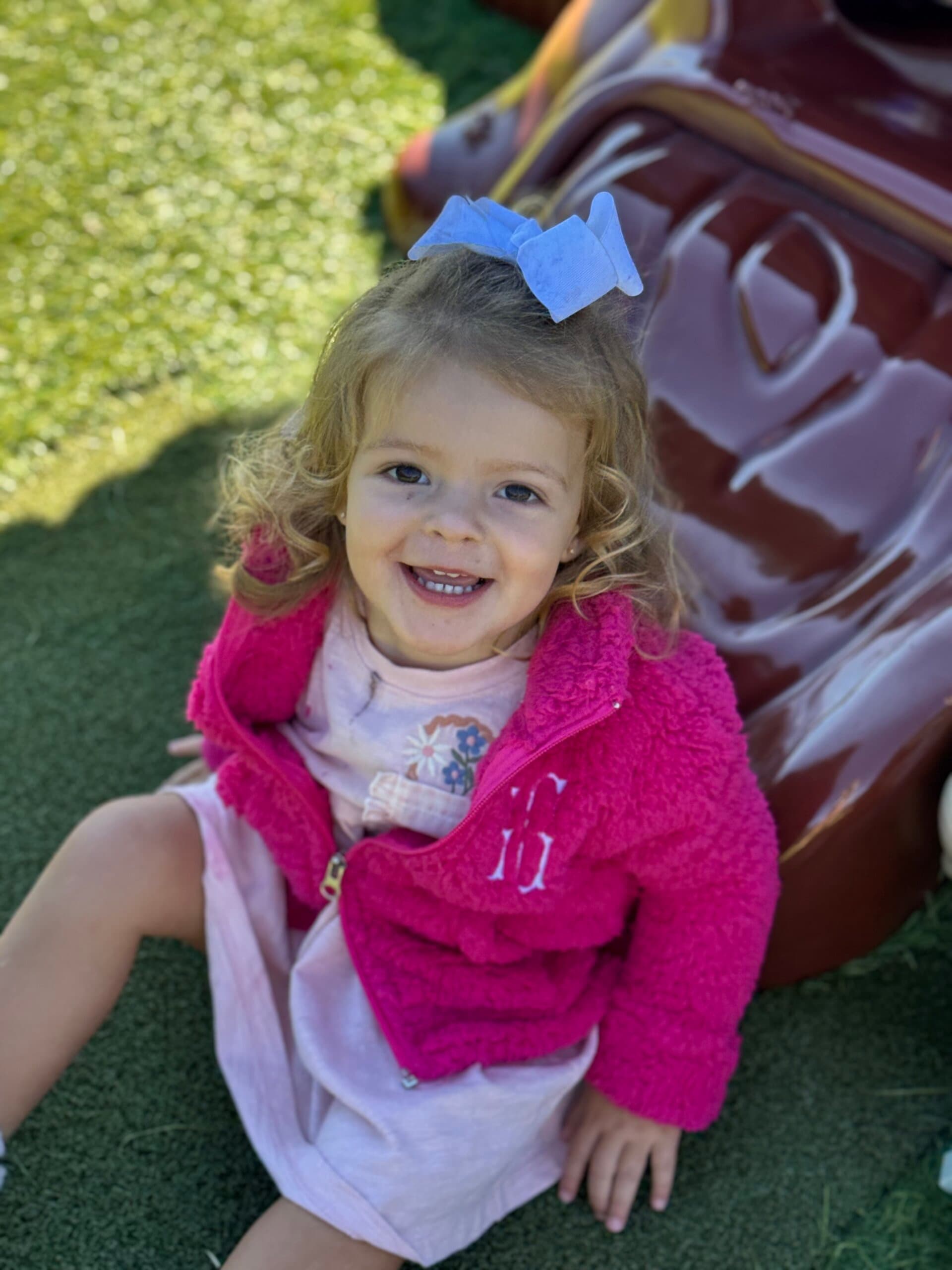 Young child smiling while enjoying outdoor playtime at Primrose School of Braselton.