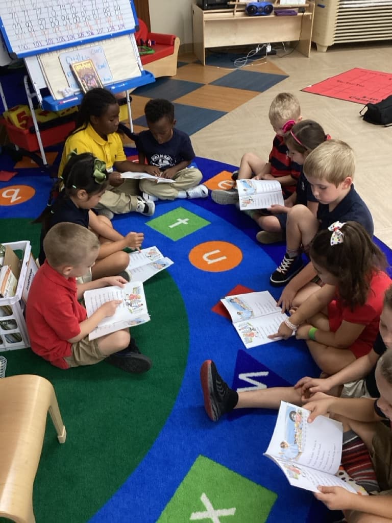 Children sitting on carpet reading