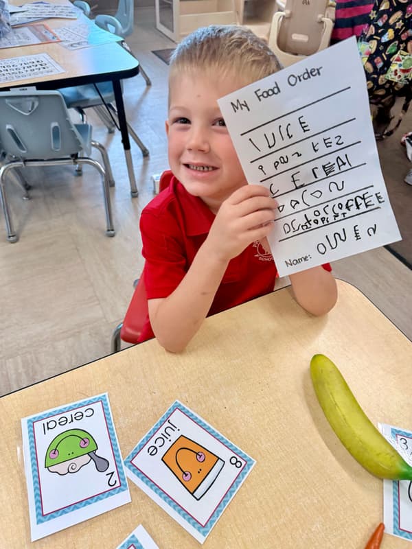 One of our Pre-Kindergarten students at Primrose School of Garden Oaks in the Writing Center.