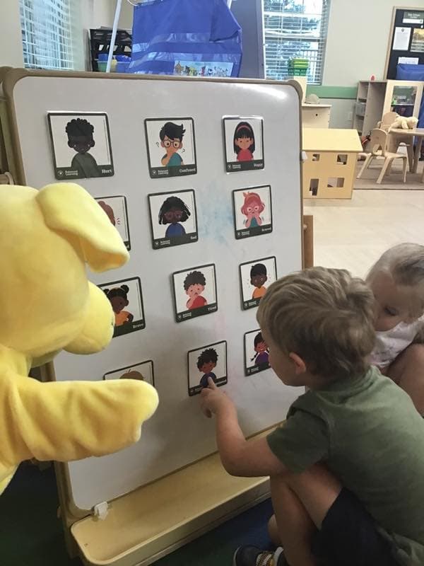 Children looking at emotion cards.