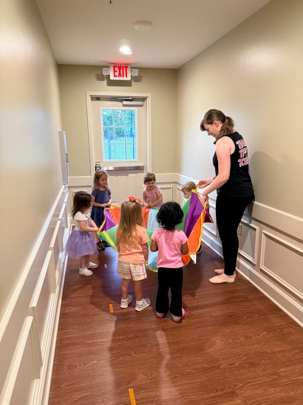 Children dancing with a parachute