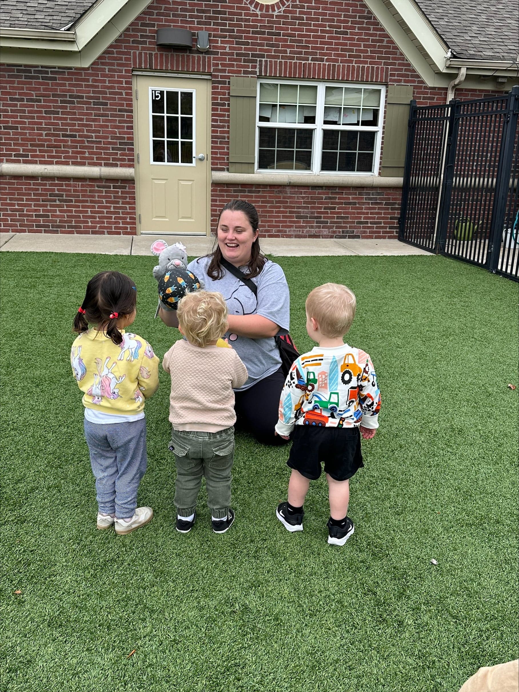 Teacher Sam leading outdoor play with early preschool children at Primrose School of Eagan preschool in Eagan, MN