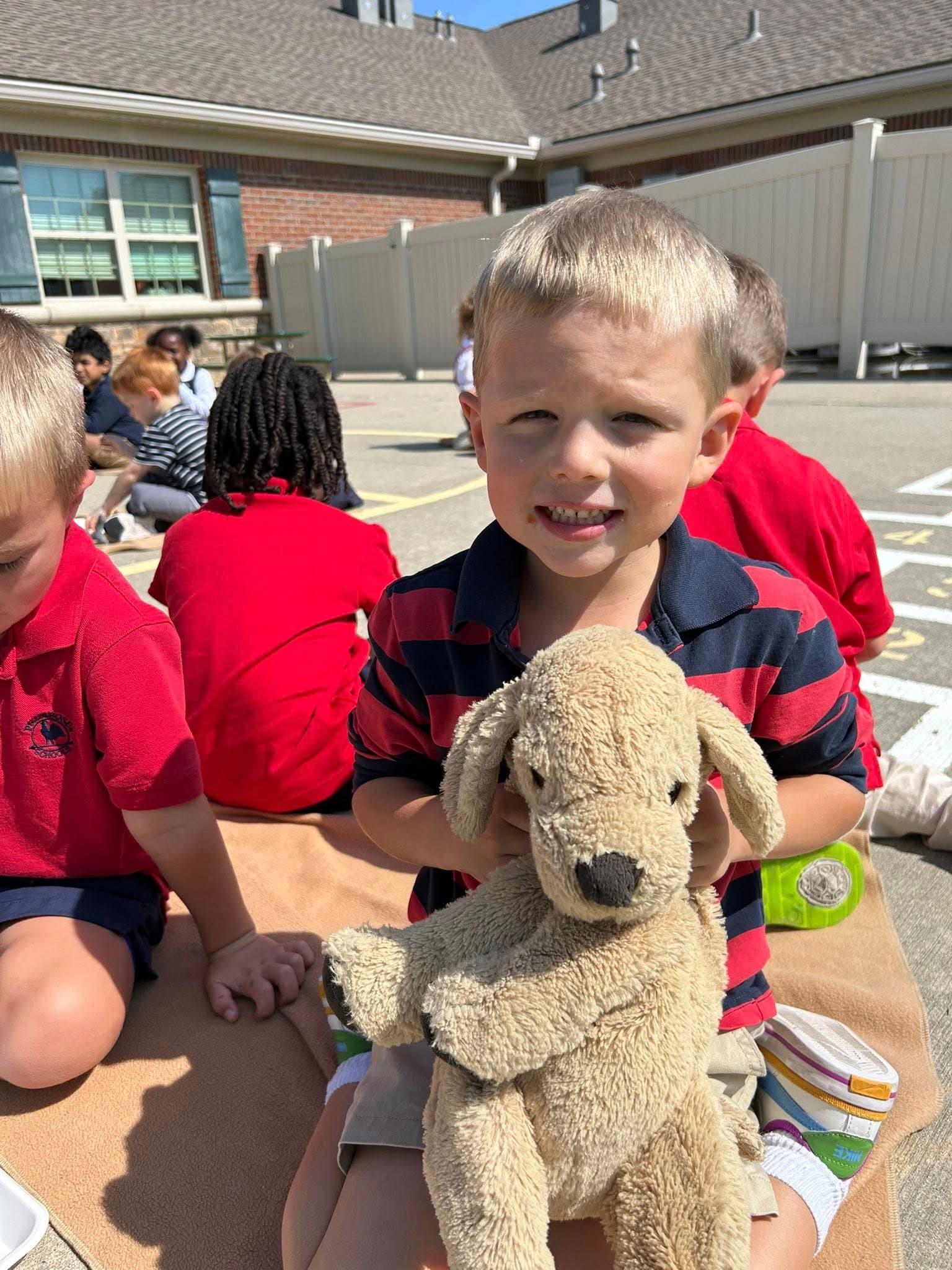 Child holding stuffed animal.