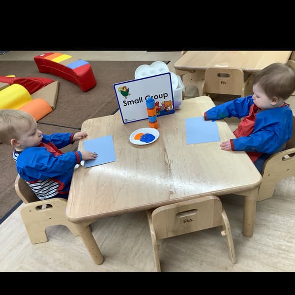 Toddlers sitting at a table