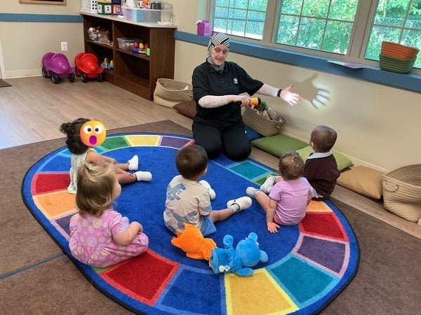 Toddler Teacher demonstrating how to make a shadow
