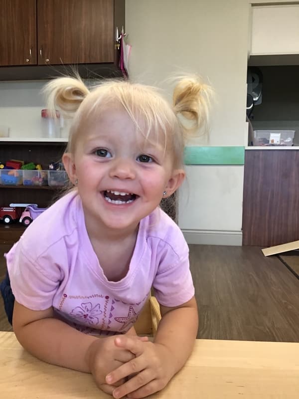 Happy Toddler excited about being at school. Caring and loving early childcare in fort worth