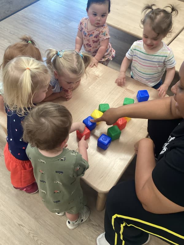 children looking at colorful blocks