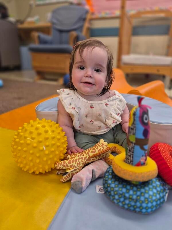 Infant participating in sensory play activities at Primrose School, supporting physical development, exploration, and confidence-building.