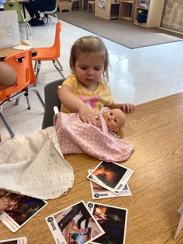 Child with baby and blanket