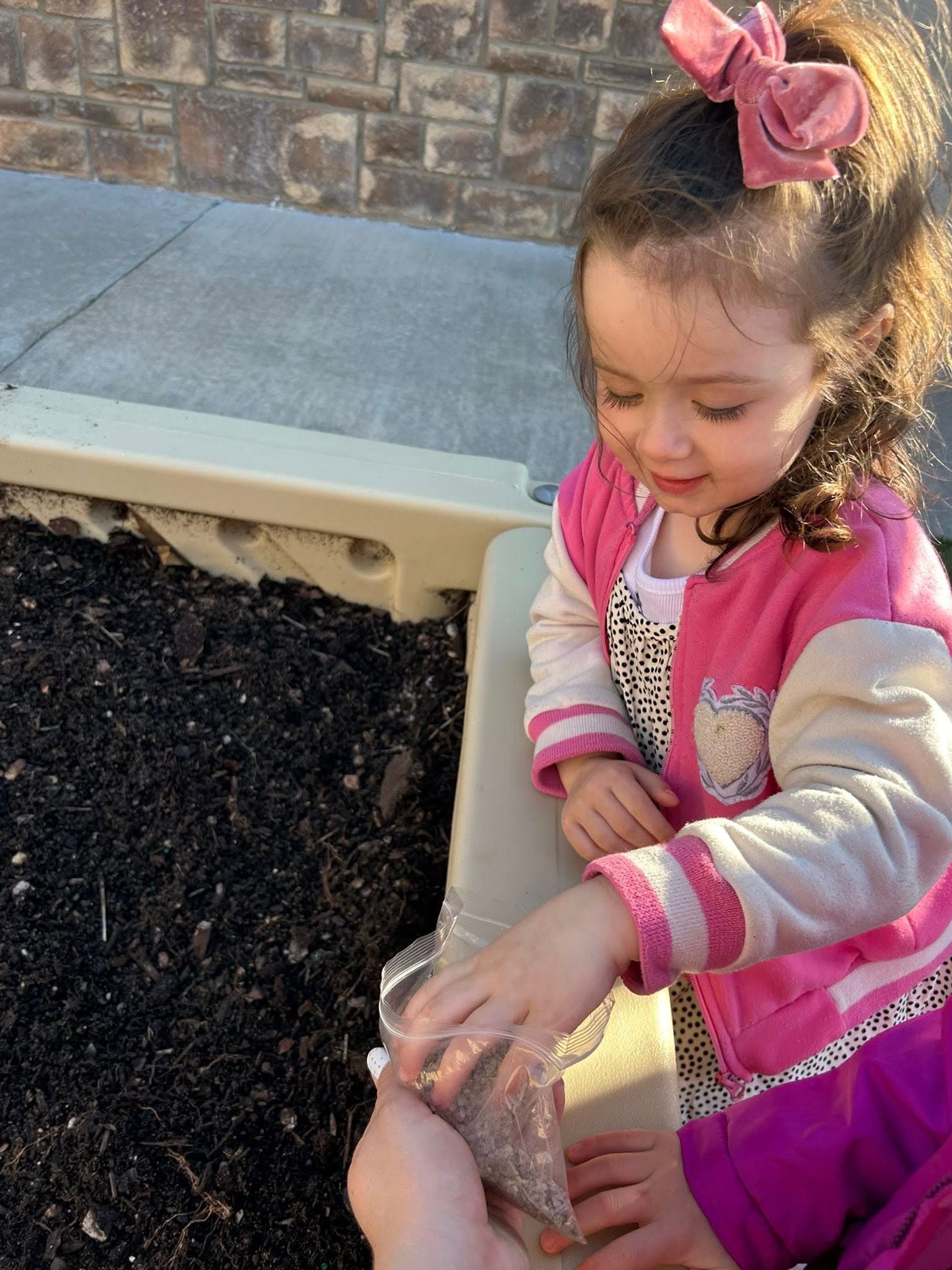 A child planting seeds in the garden
