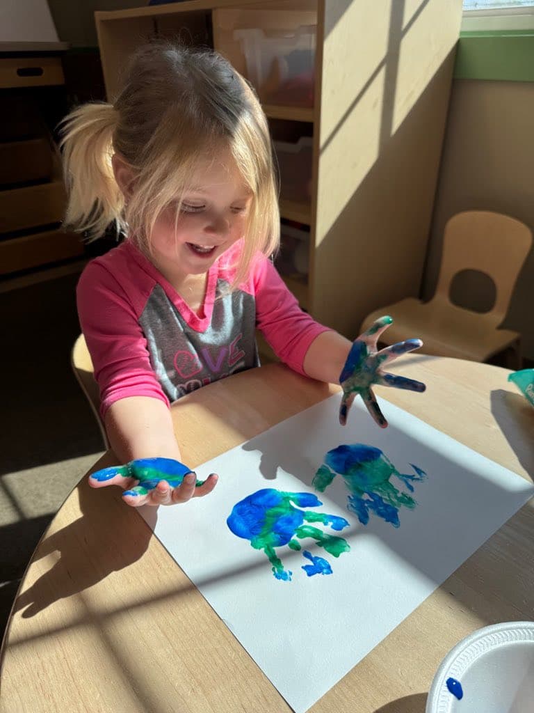 A student from Early Preschool III working on their Earth Day art project