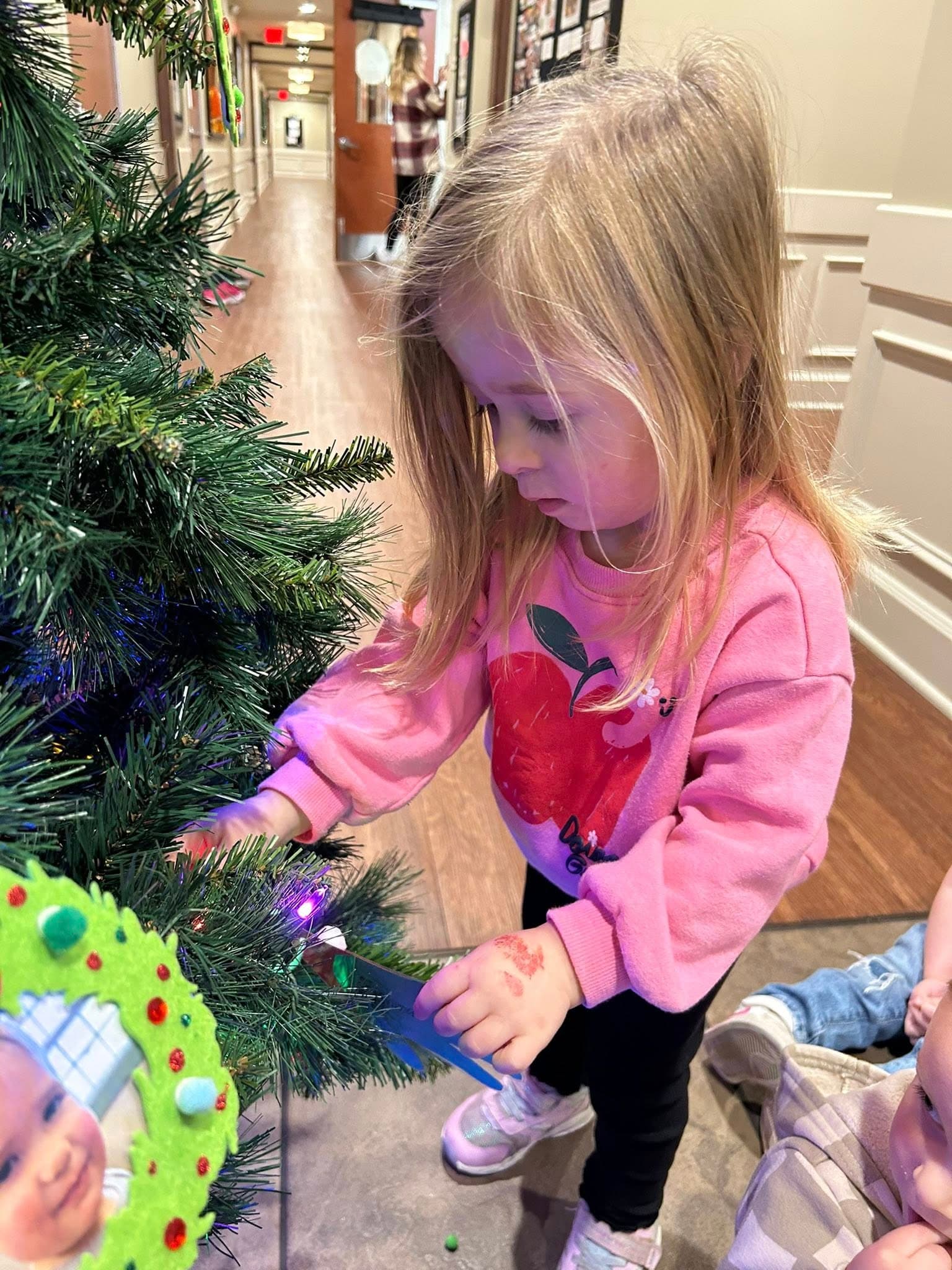 A child decorating the tree