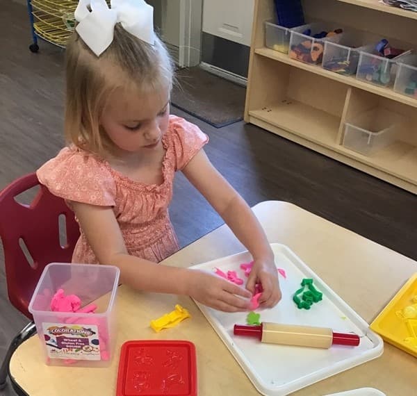 after school care for school aged children , kindergartener playing with play dough after school care in haslet area