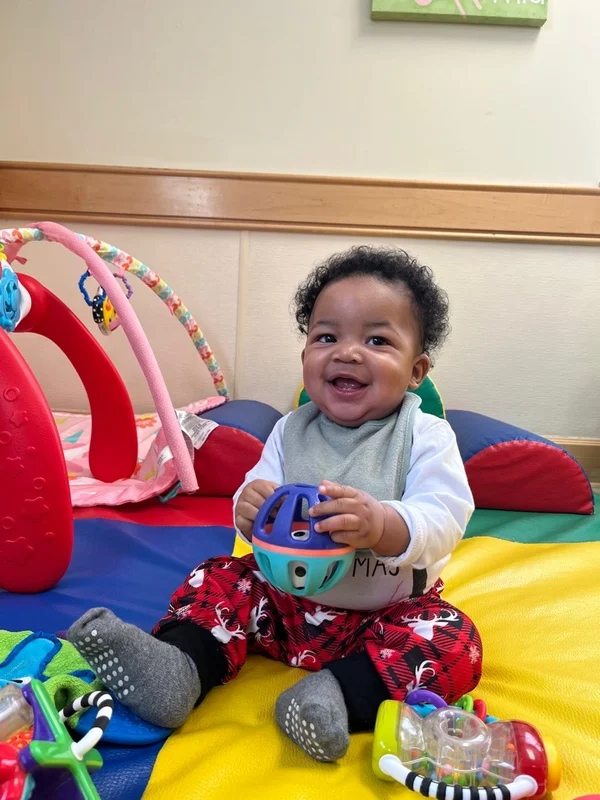 infant child discovering a ball and what it can do.