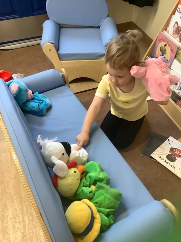 Child playing with puppets