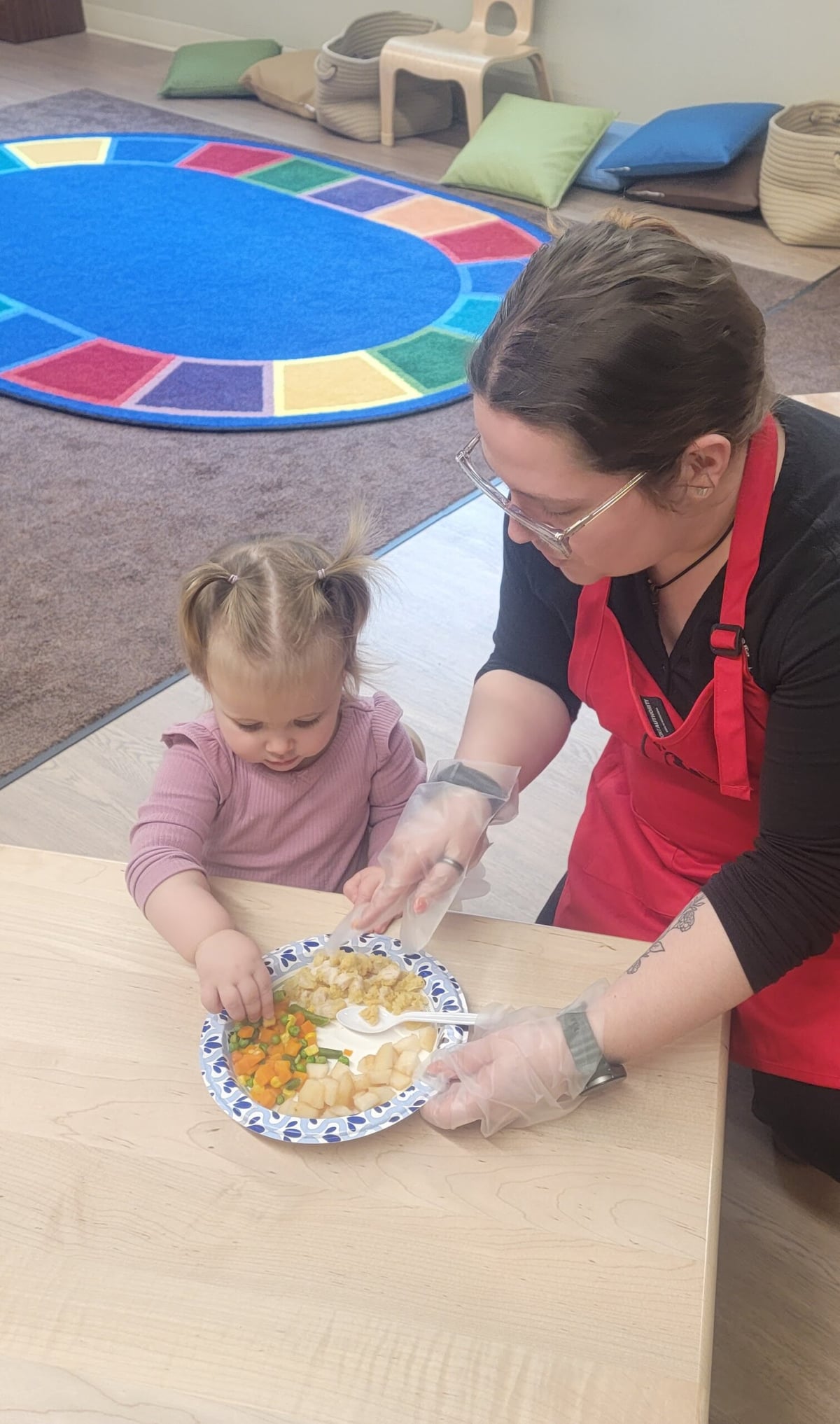 A child being served their lunch.