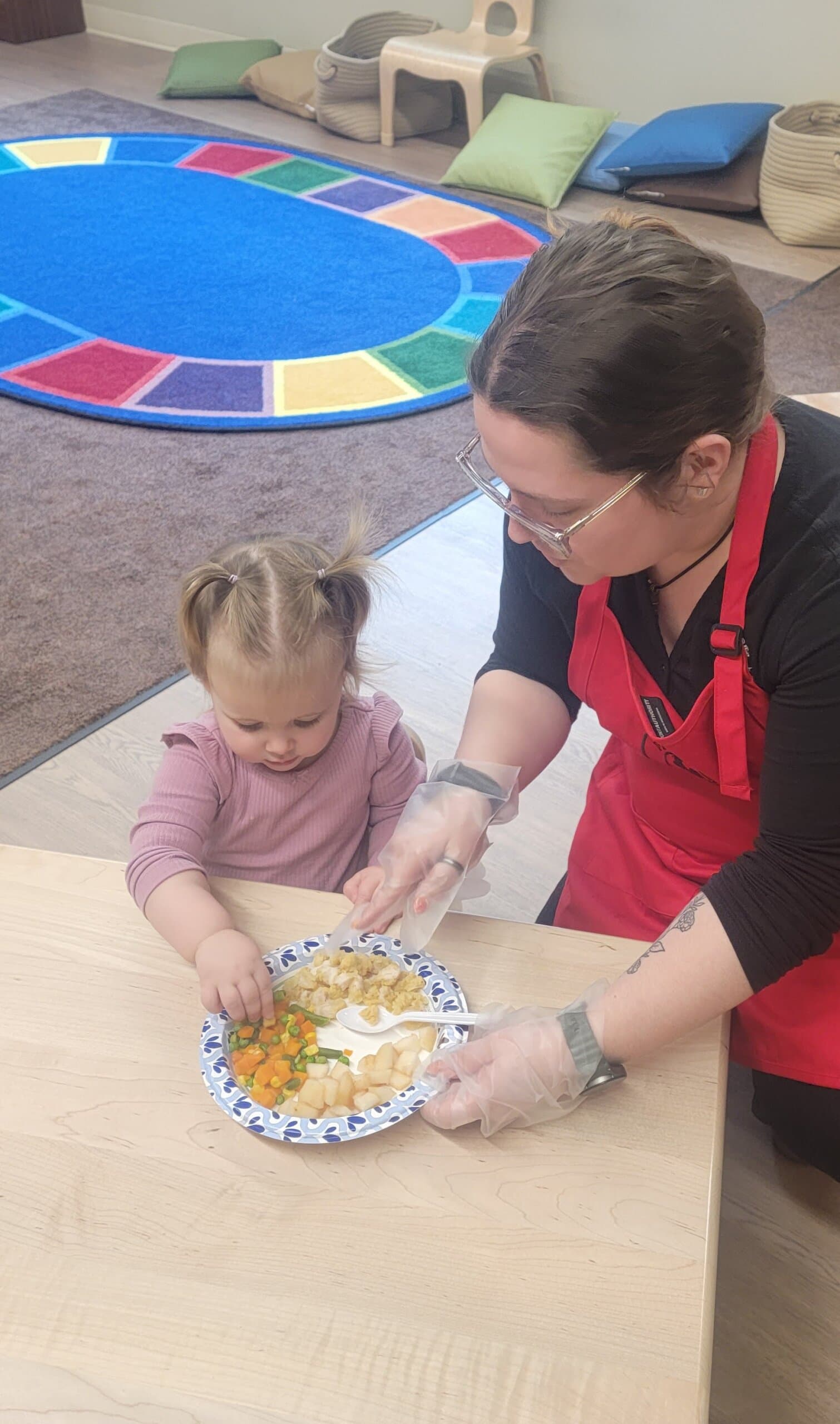 A child being served their lunch.