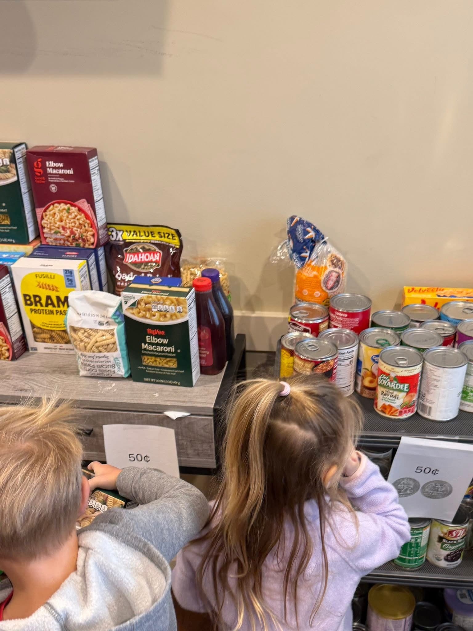 Students purchasing food for our Caring and Giving food drive, we collected 693 items