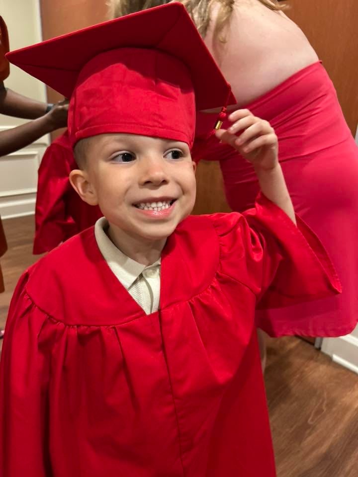 a child smiling at graduation