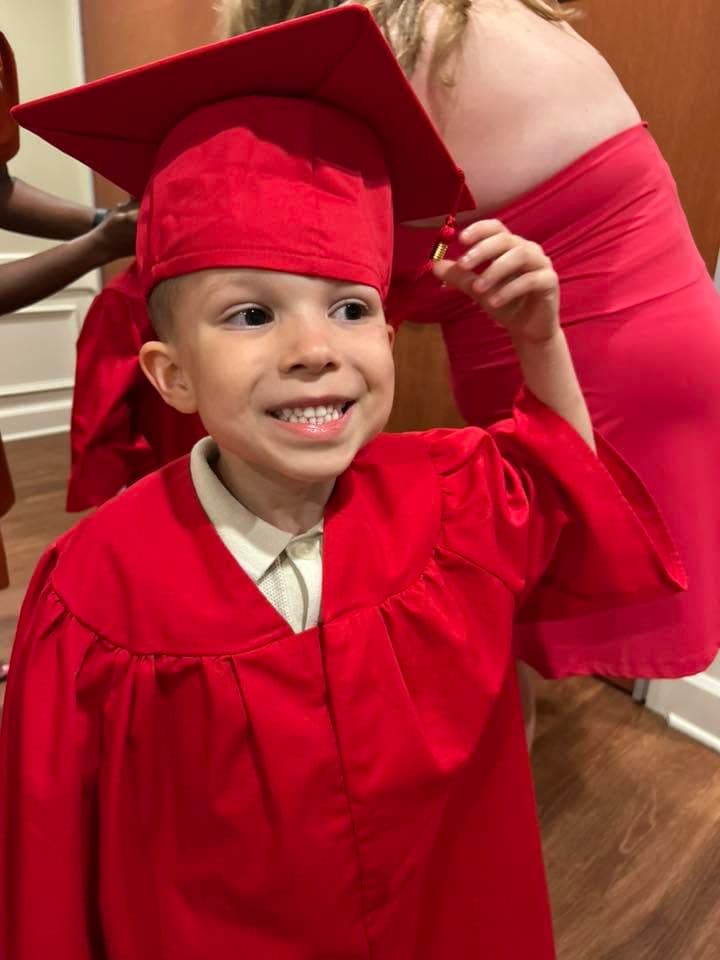 a child smiling at graduation