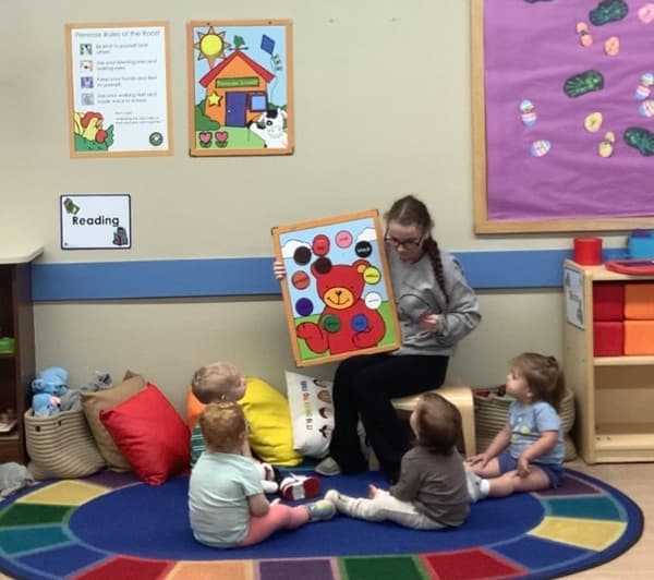 children sitting on the carpet learning colors