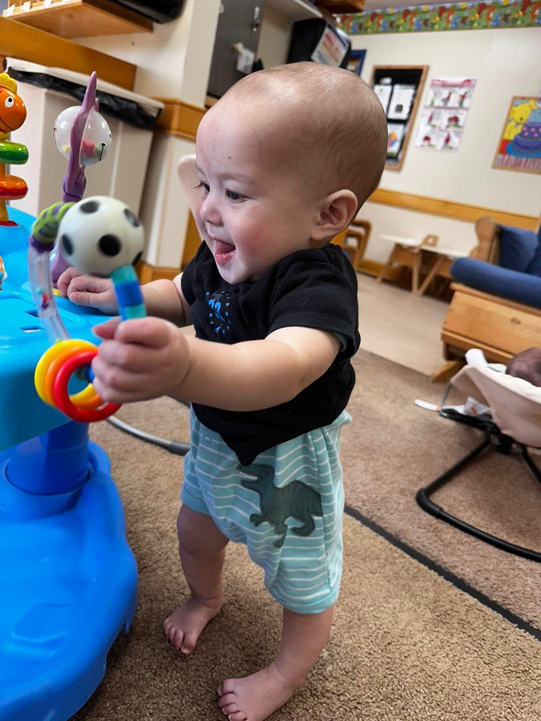 gross motor, pulling up, infancy, daycare, smile