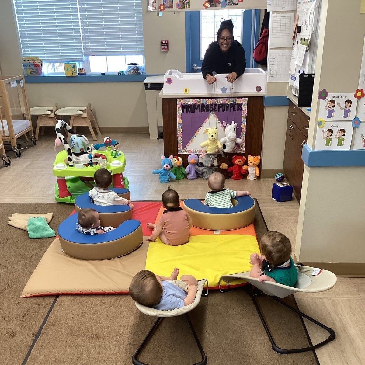 Teacher performing a Primrose Puppets show for infants in the infant classroom at Primrose School of Woburn, MA
