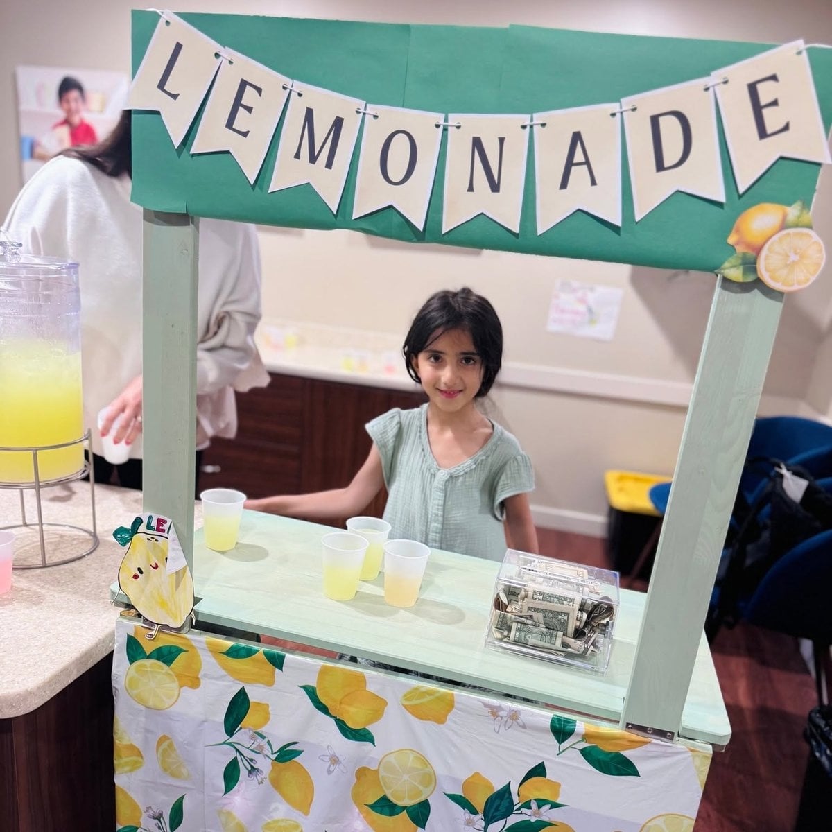 Kindergarten child running a lemonade stand during an entrepreneurship activity at Primrose School of Woburn, MA