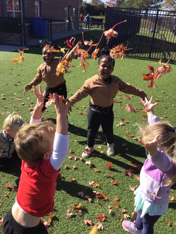 Children playing in leaves.