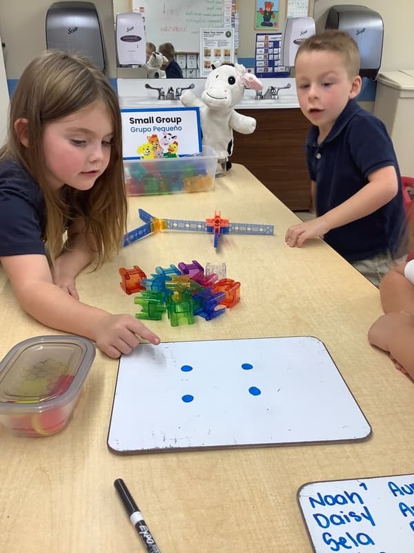 Children at a table doing math