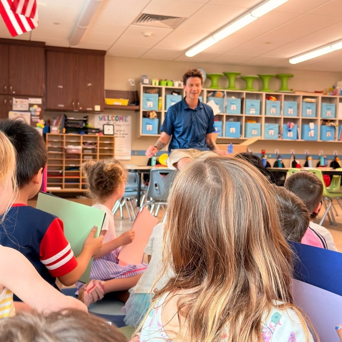 Pre-K children visiting a Kindergarten classroom with a teacher during a school readiness activity at Primrose School of Woburn, MA