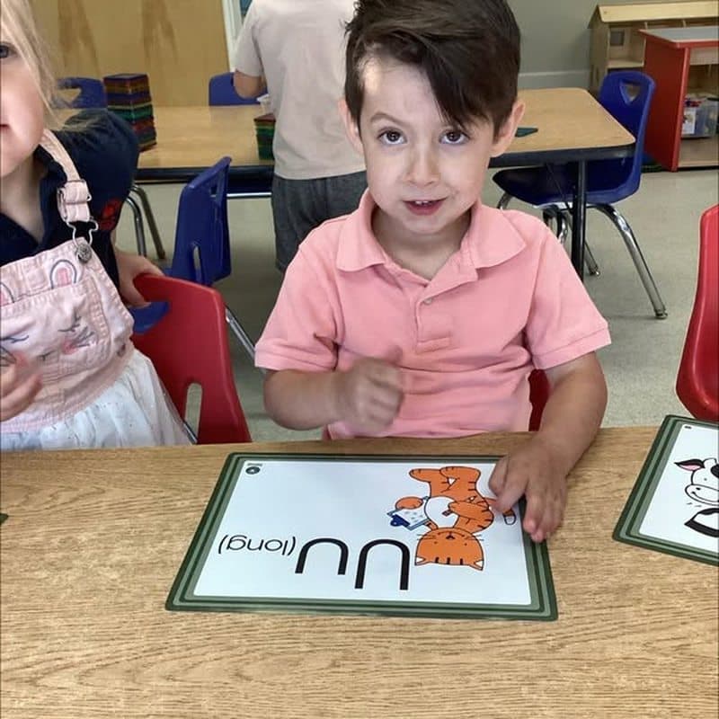 Pre-Kindergarten student practicing letter recognition with an alphabet learning activity at Primrose School at Highlands Ranch Business Park in Highlands Ranch, CO.