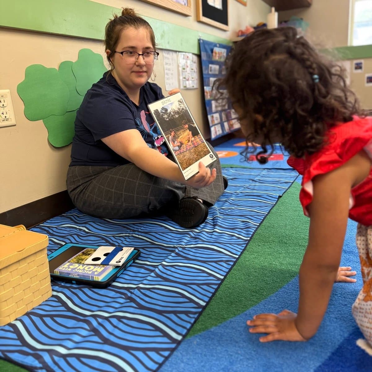 Preschool girl exploring classroom learning materials during Preschool Pathways program at Primrose School of Chelmsford, MA