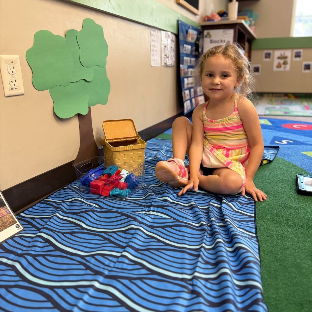 Teacher reading with a preschool child during Preschool Pathways classroom activity at Primrose School of Chelmsford, MA