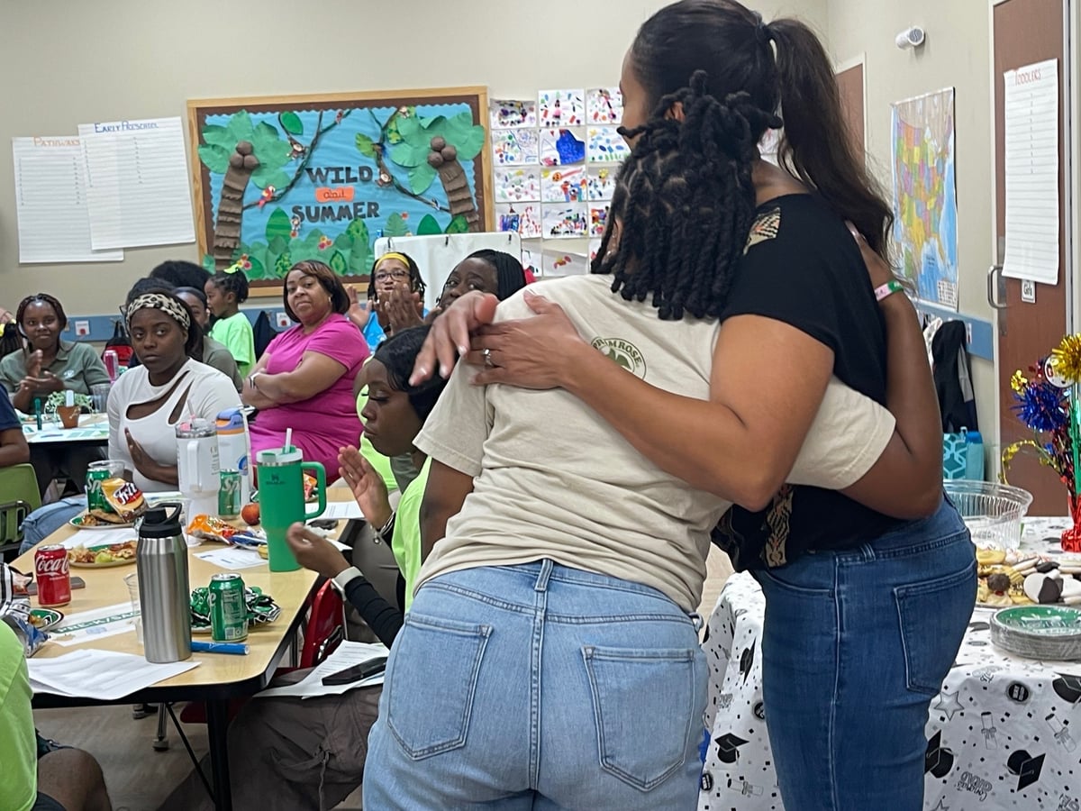 two teachers hugging