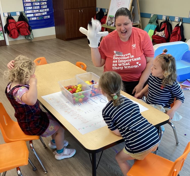 three kids sitting with teacher practicing patterns