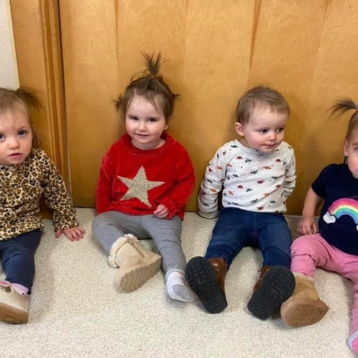 Four toddlers sitting together in a classroom at Primrose School at Highlands Ranch Business Park in Highlands Ranch, CO.
