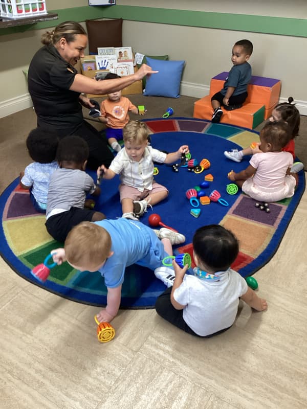Teacher uses sign language in toddler classroom during music time