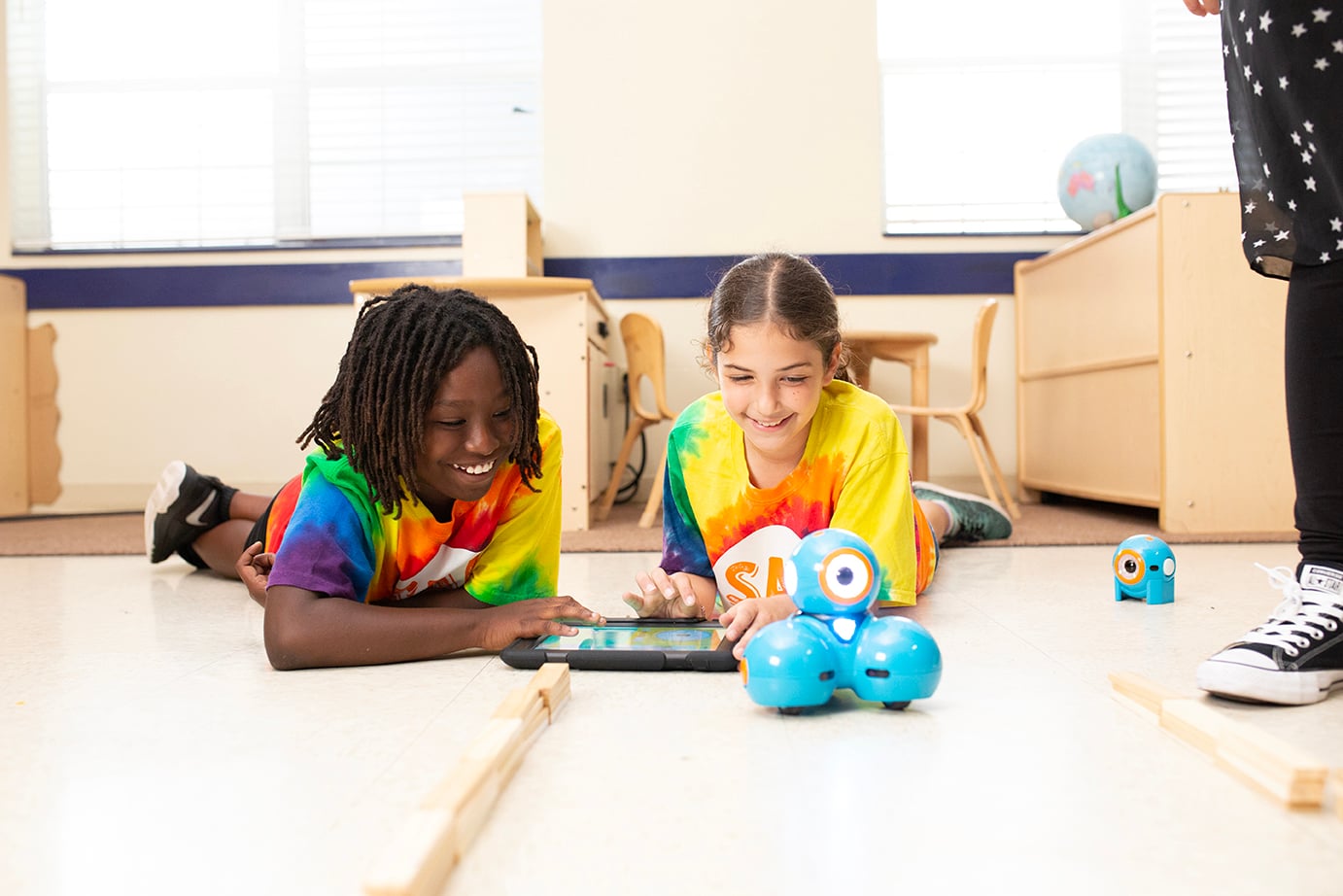 two children playing with robot