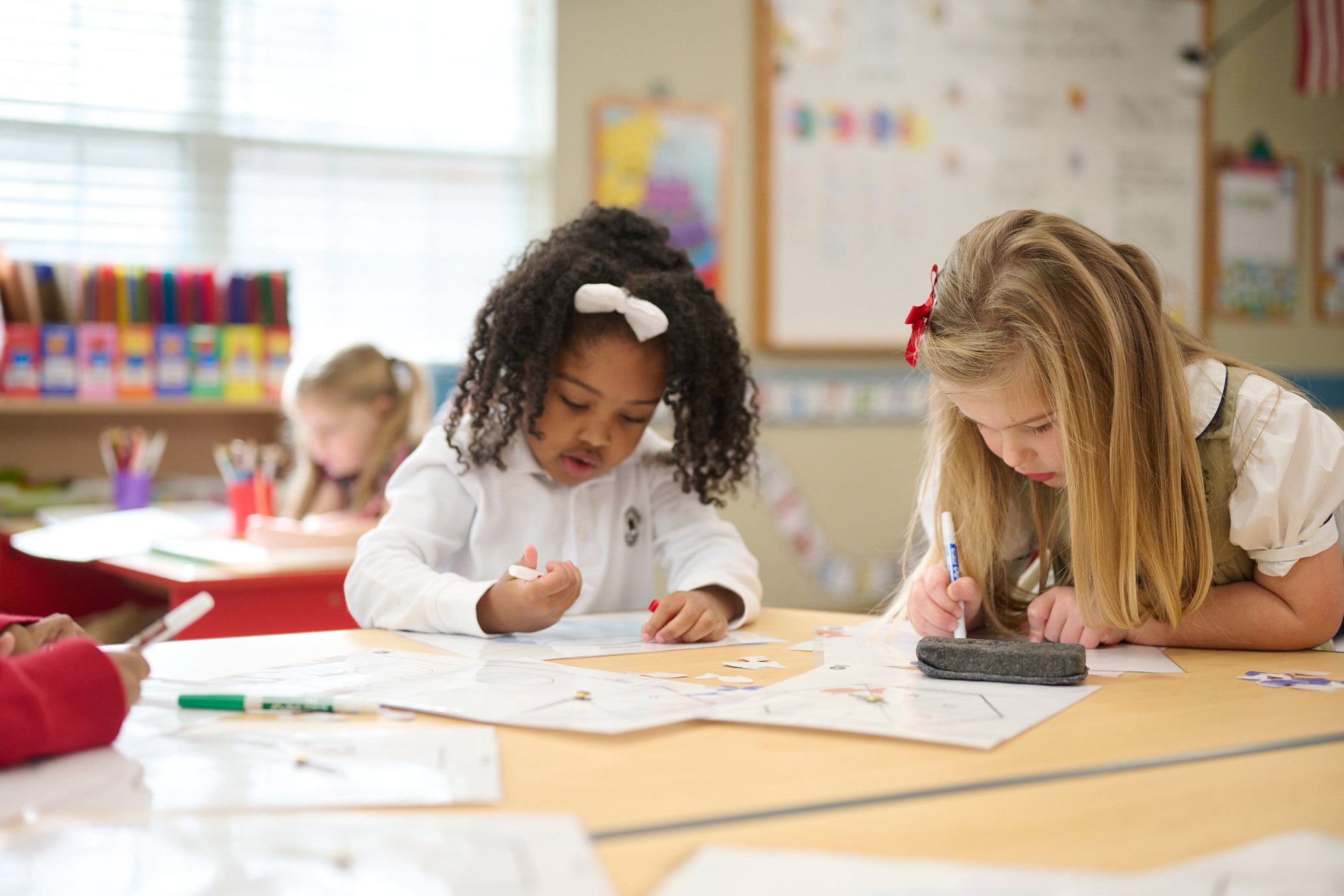 two kindergarten children completing classwork together