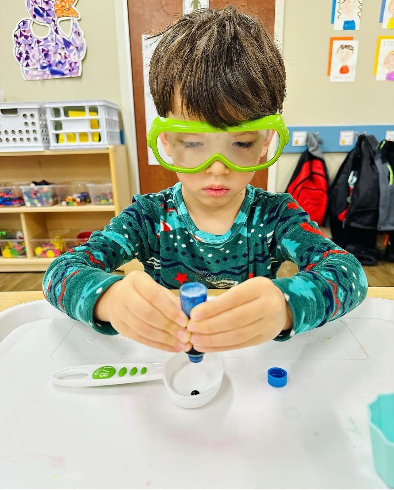 Pre-Kindergarten student using food coloring for activity