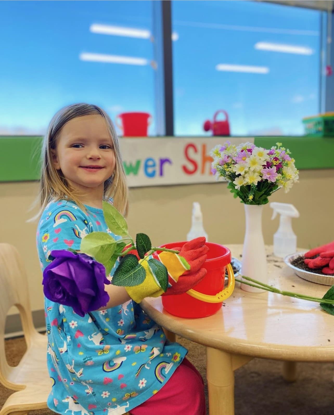 Preschool student planting flower