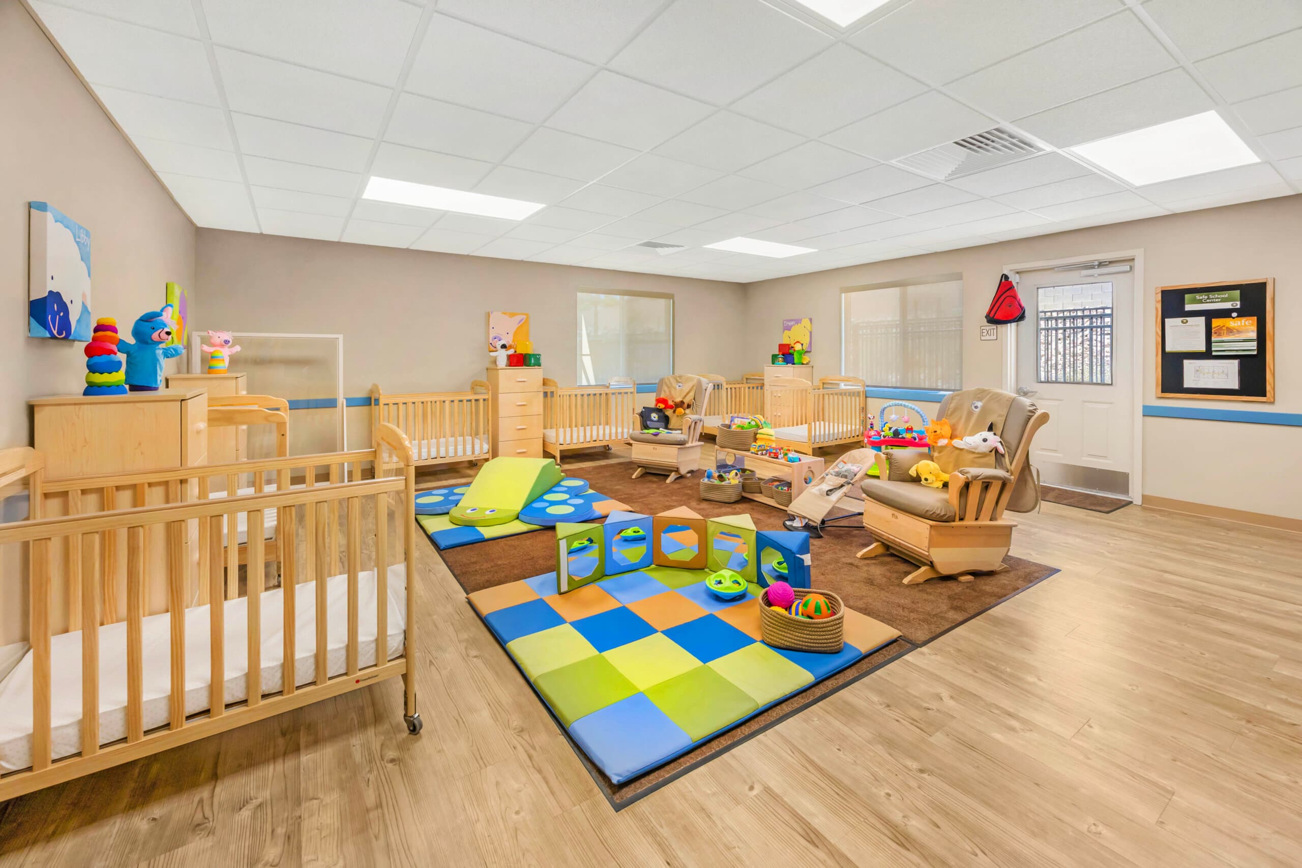 infant classroom for children 6-weeks - 12 months old with play mats and beautiful wooden furniture