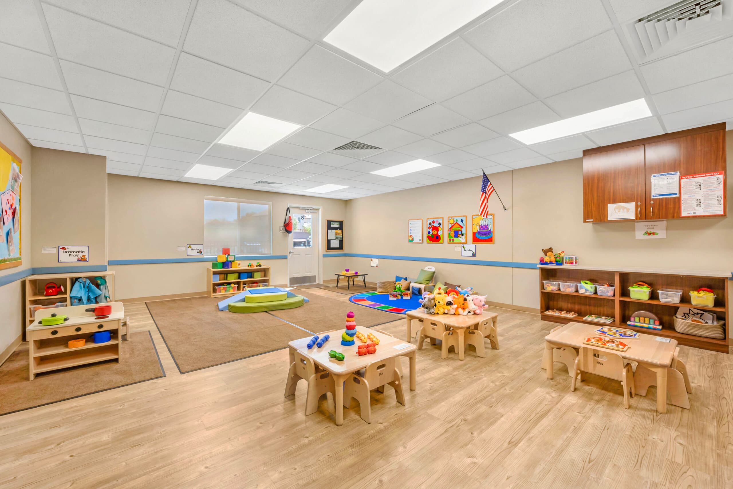 Spacious toddler classroom with colorful toys and age appropriate furniture
