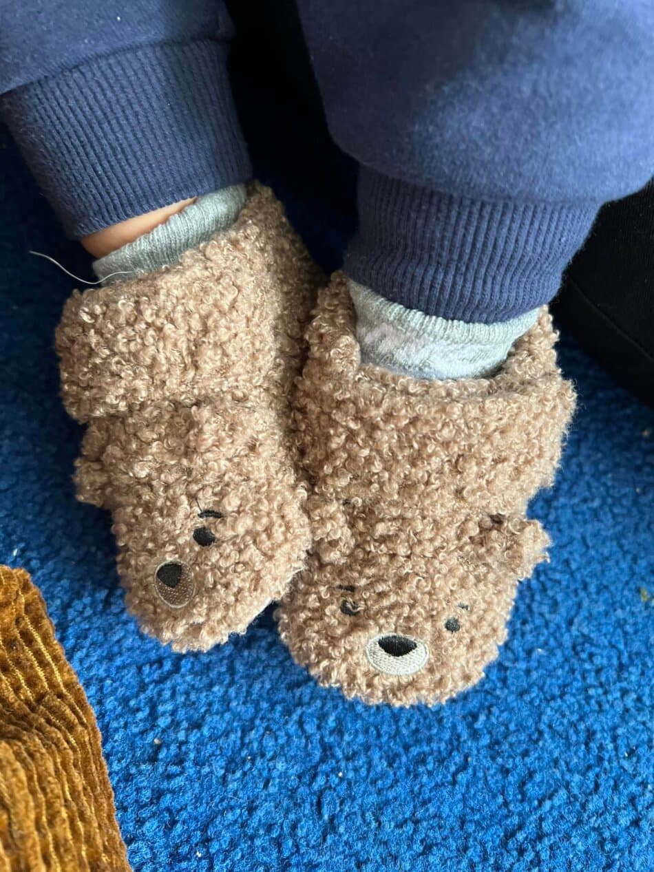 infant child's feet with slippers