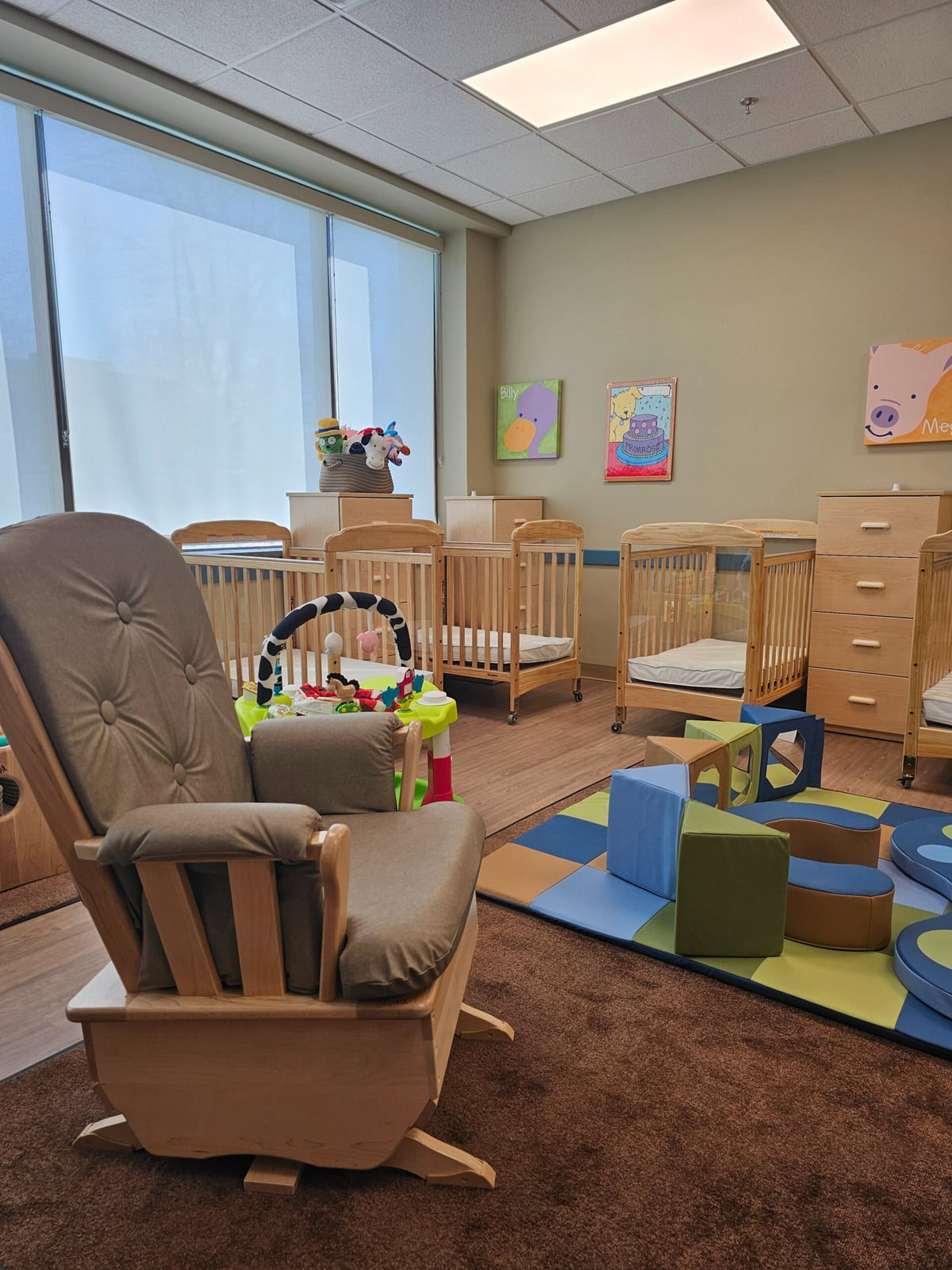 infant room with crib and chair