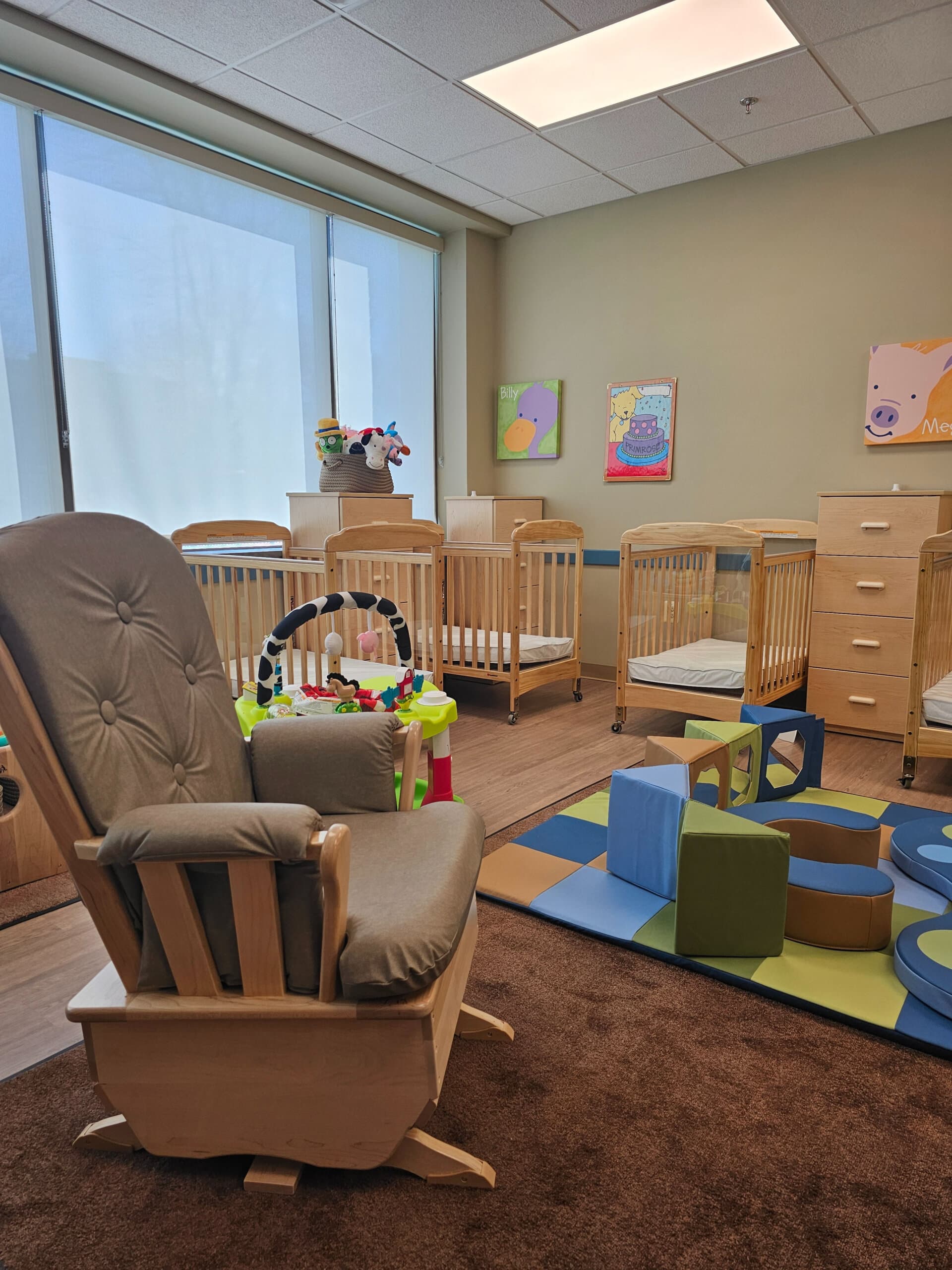 infant room with crib and chair