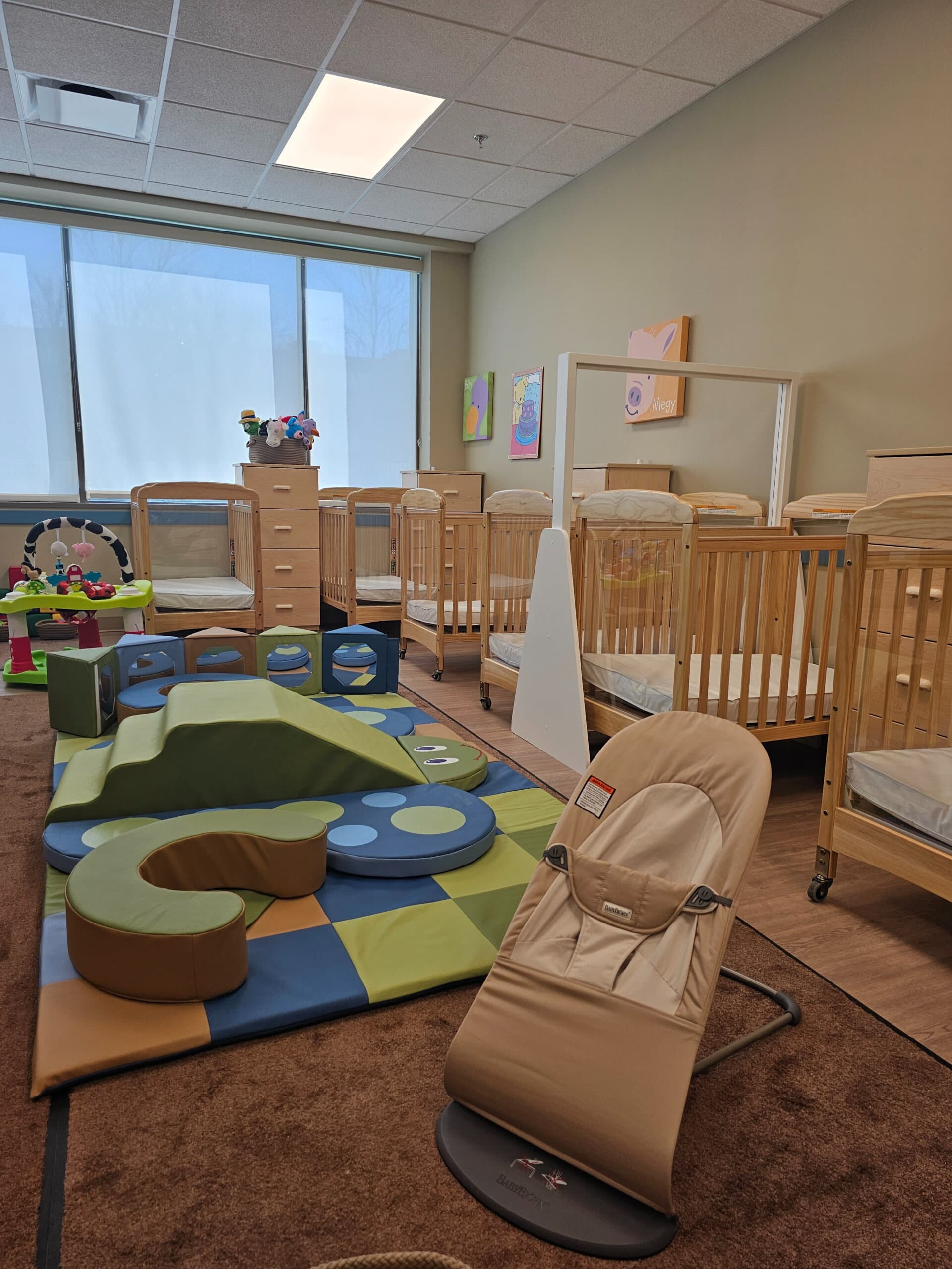 infant room with crib and chair